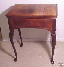 A Queen Anne style sewing machine cabinet