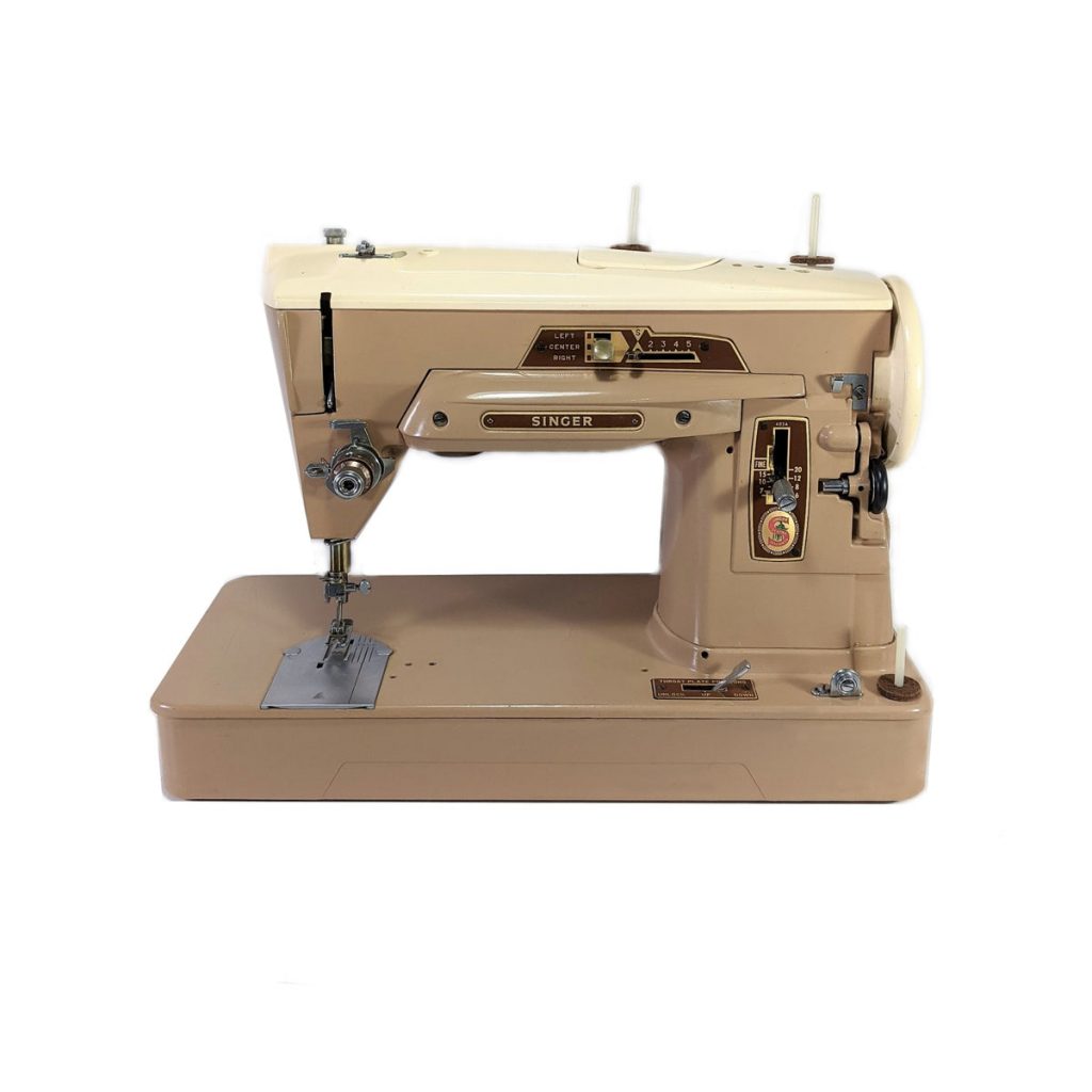 A mid-century beige sewing machine