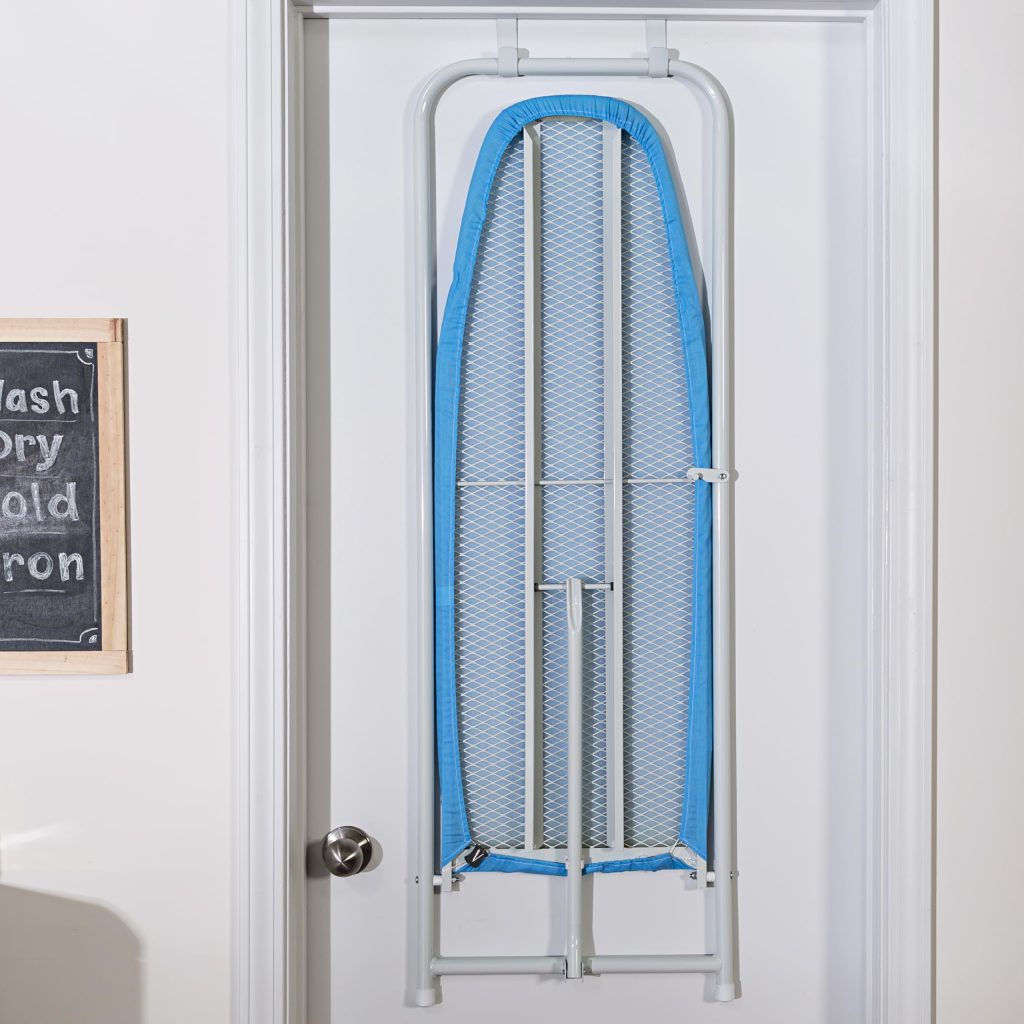 An ironing board hanging on a door